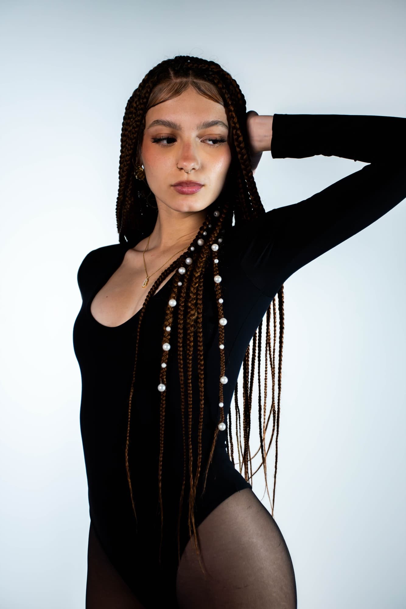 Pearled braids falling over the bodysuit