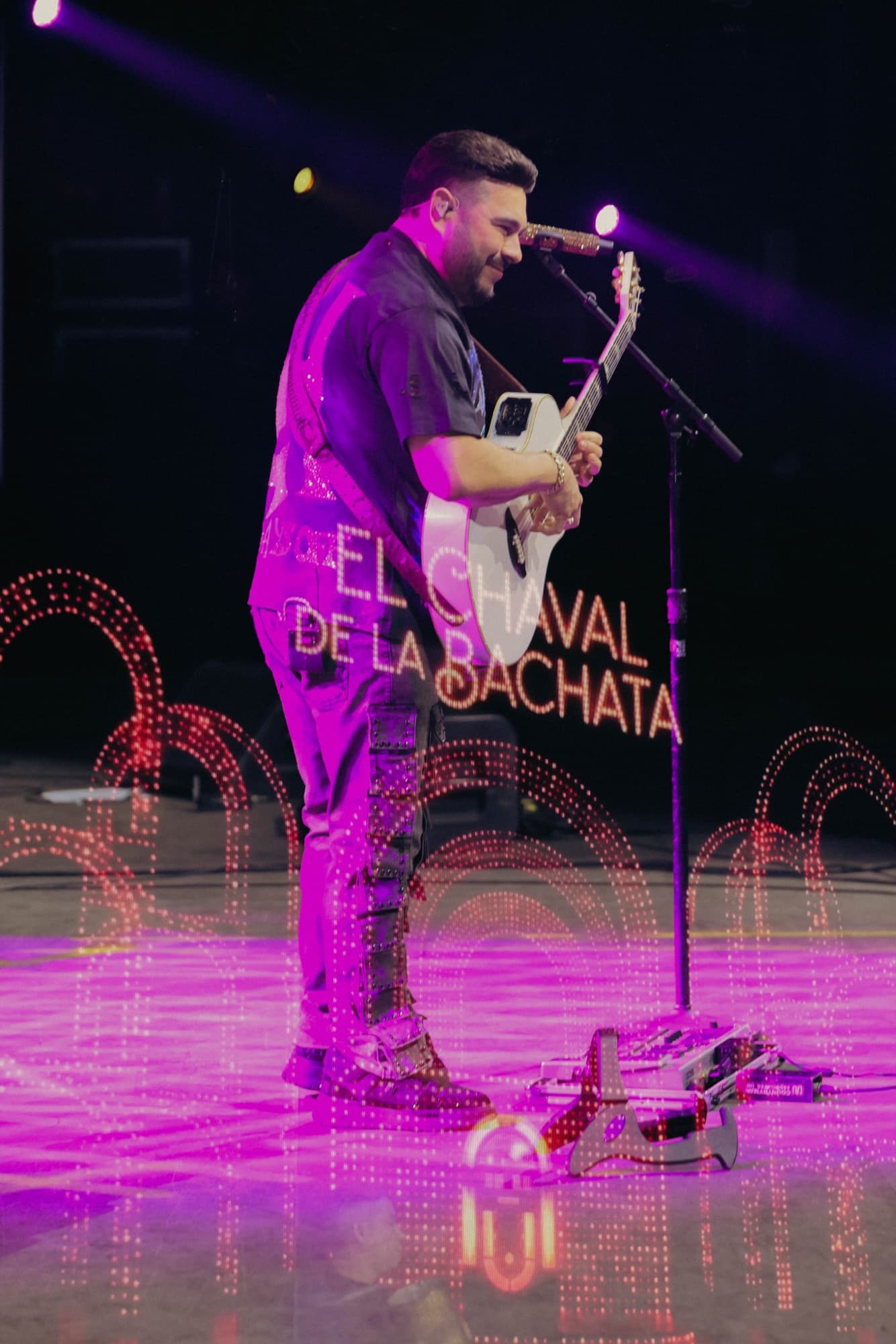 Purple-lit performance under the LED marquee