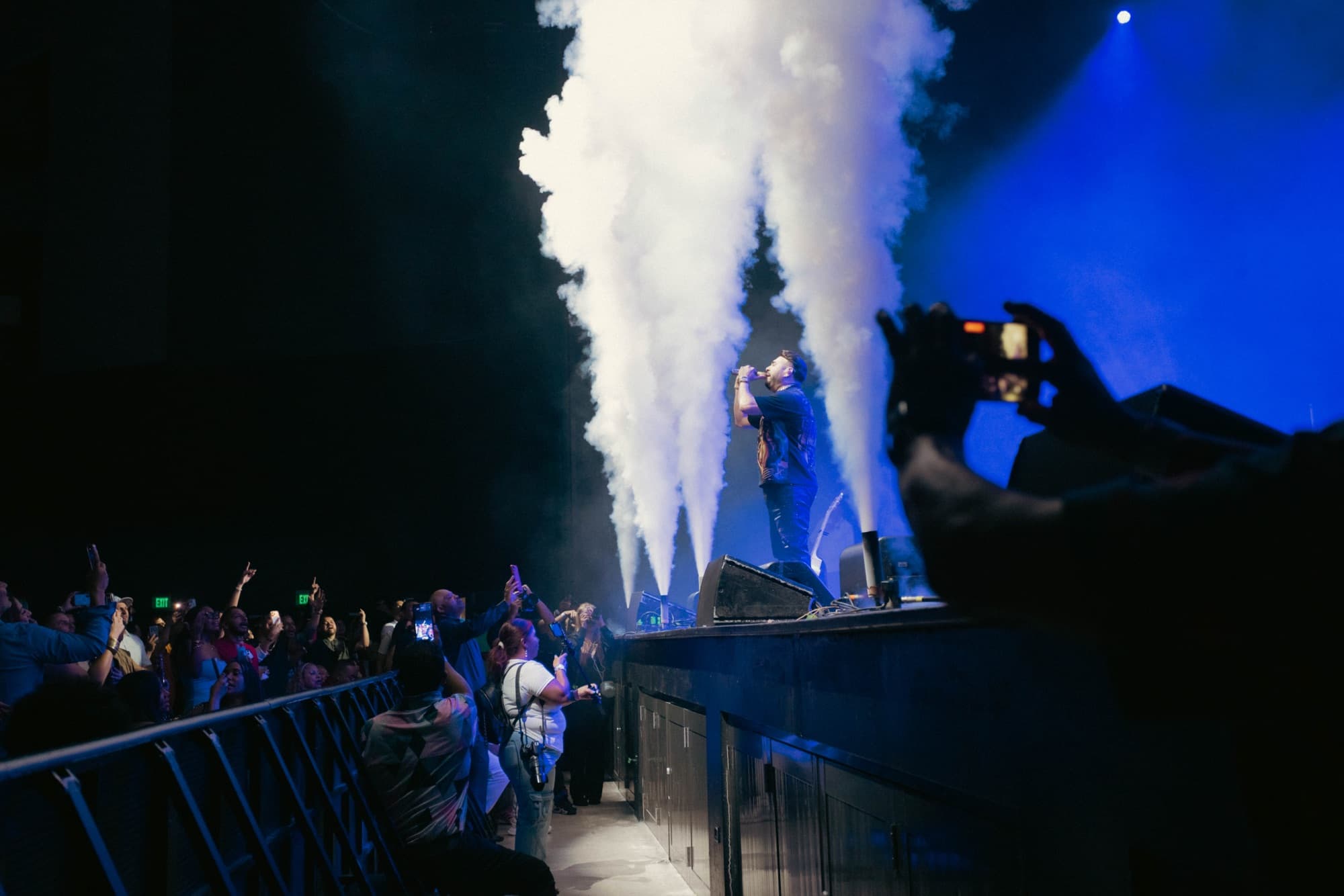 Smoke jets erupting as he sings at the stage edge
