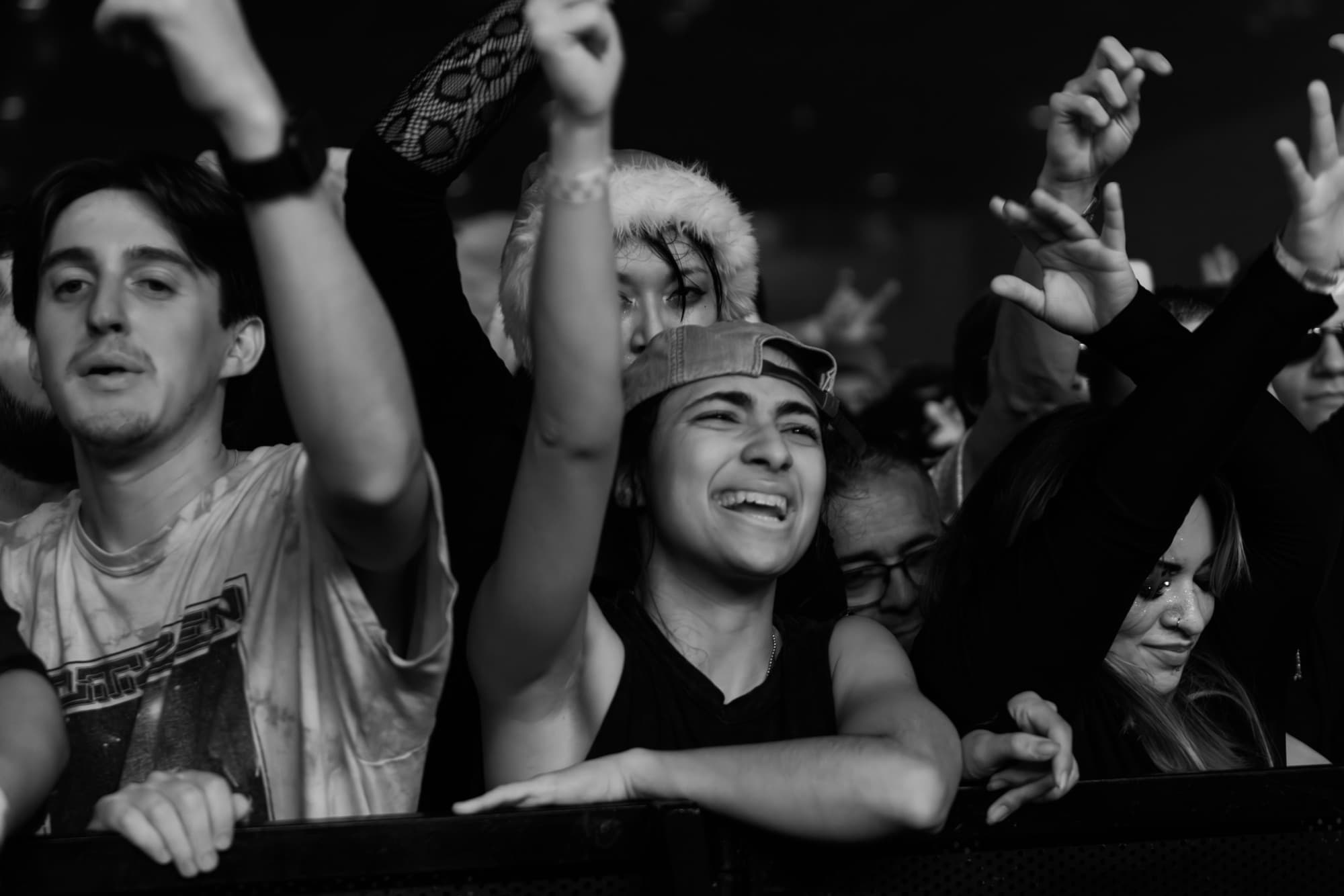 Friends in Santa hats laughing in black and white