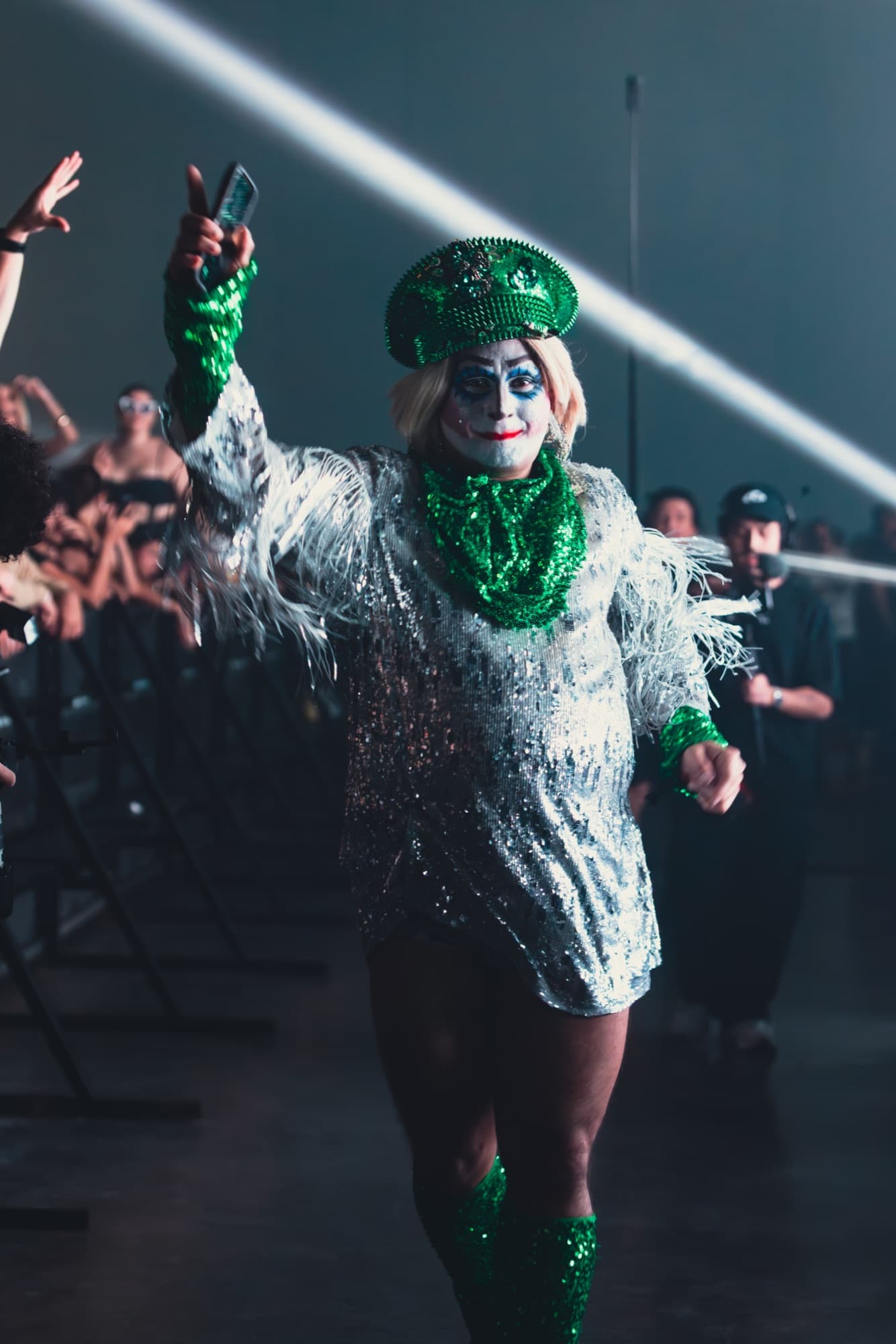 Performer in green sequins and painted face