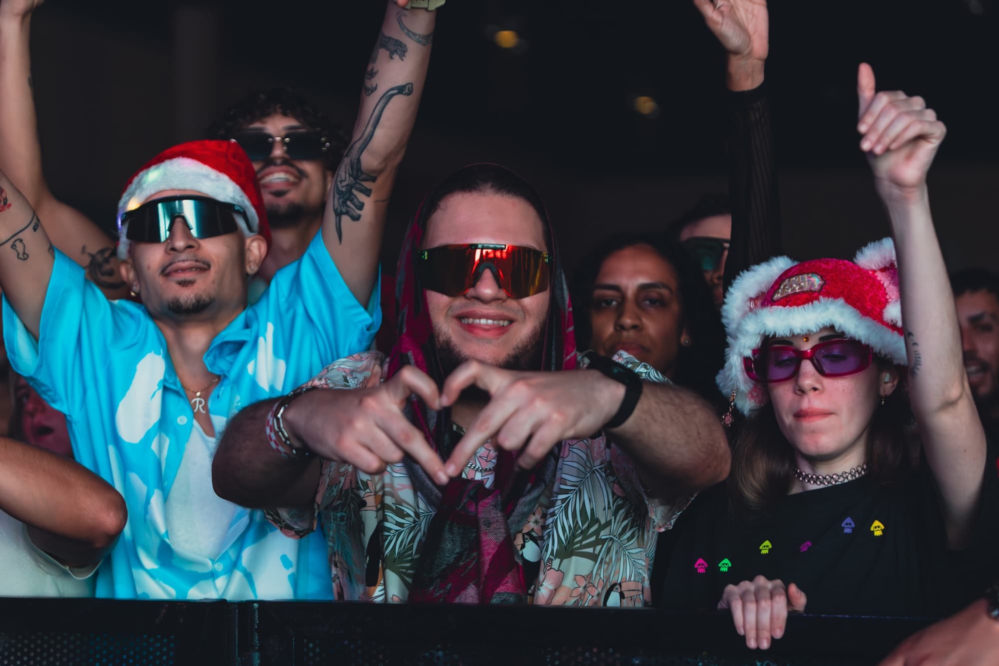 Fan making a heart with his hands at the rail