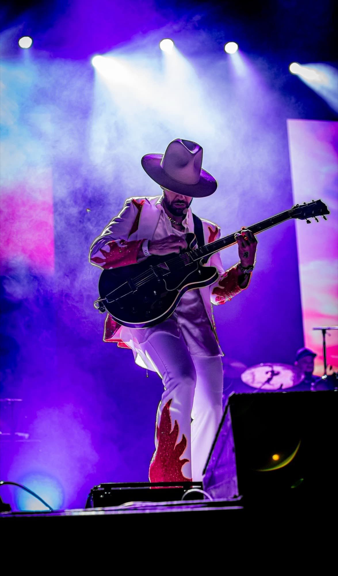 Jesse in a hat smiling at the crowd