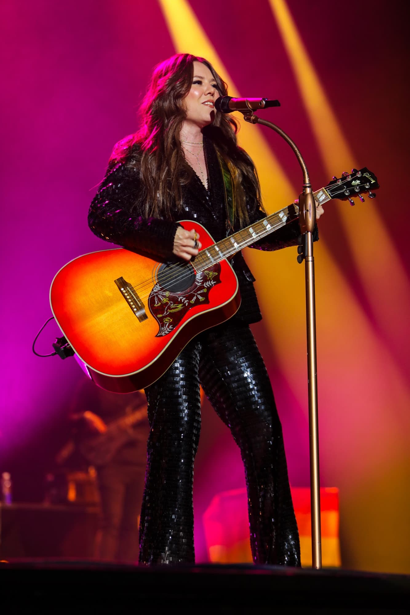 Joy singing under magenta light
