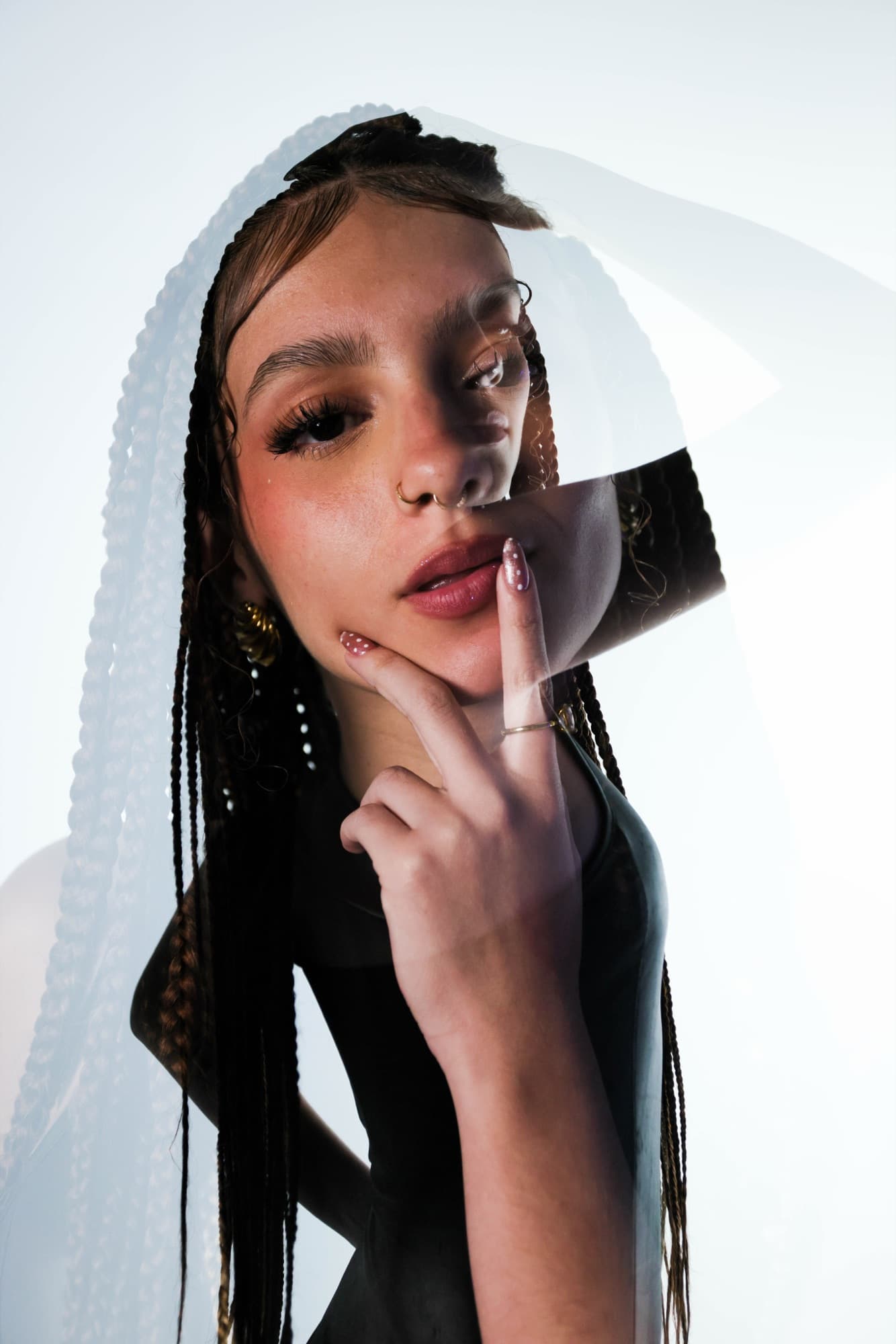 Portrait with braids framed by a translucent veil