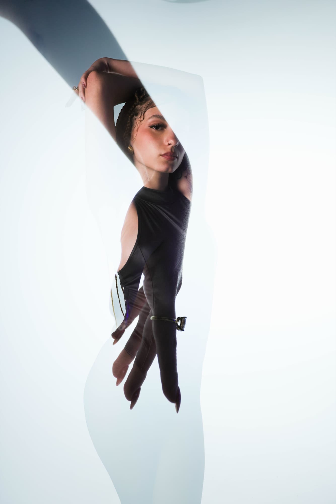 Portrait shot through translucent fabric in cool studio light