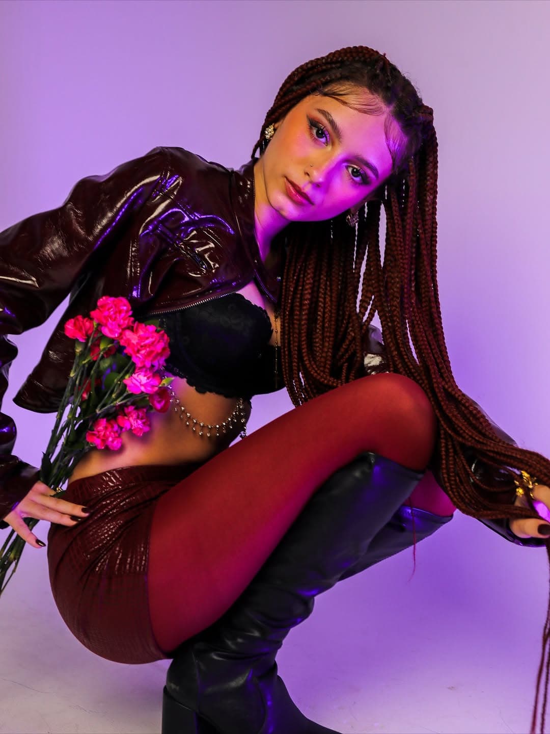 Tattoo artist styled in oxblood patent leather